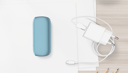 Turquoise IQOS ORIGINALS DUO pocket charger next to cable charger.